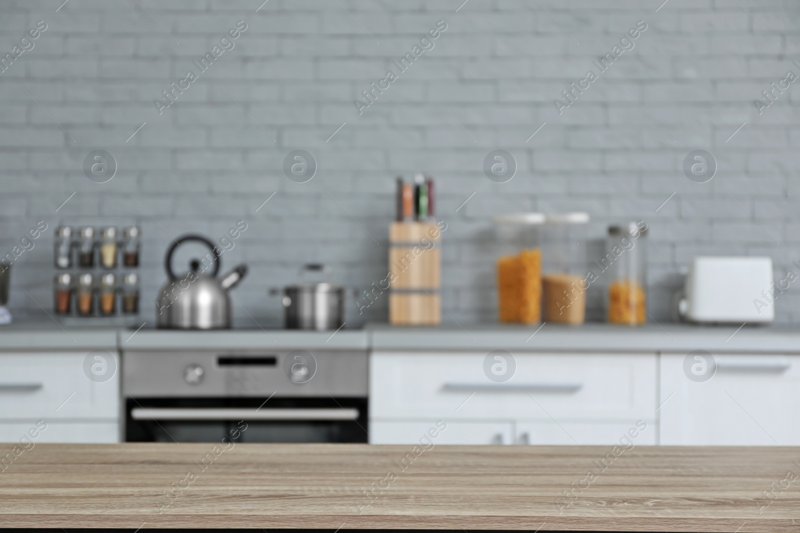 Photo of Empty table and blurred view of kitchen interior