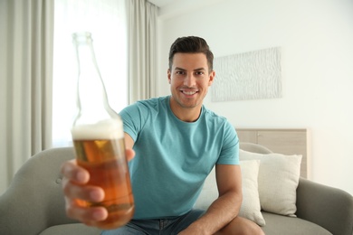 Man drinking beer while having online video conference at home, view from web camera. Social distancing during coronavirus pandemic