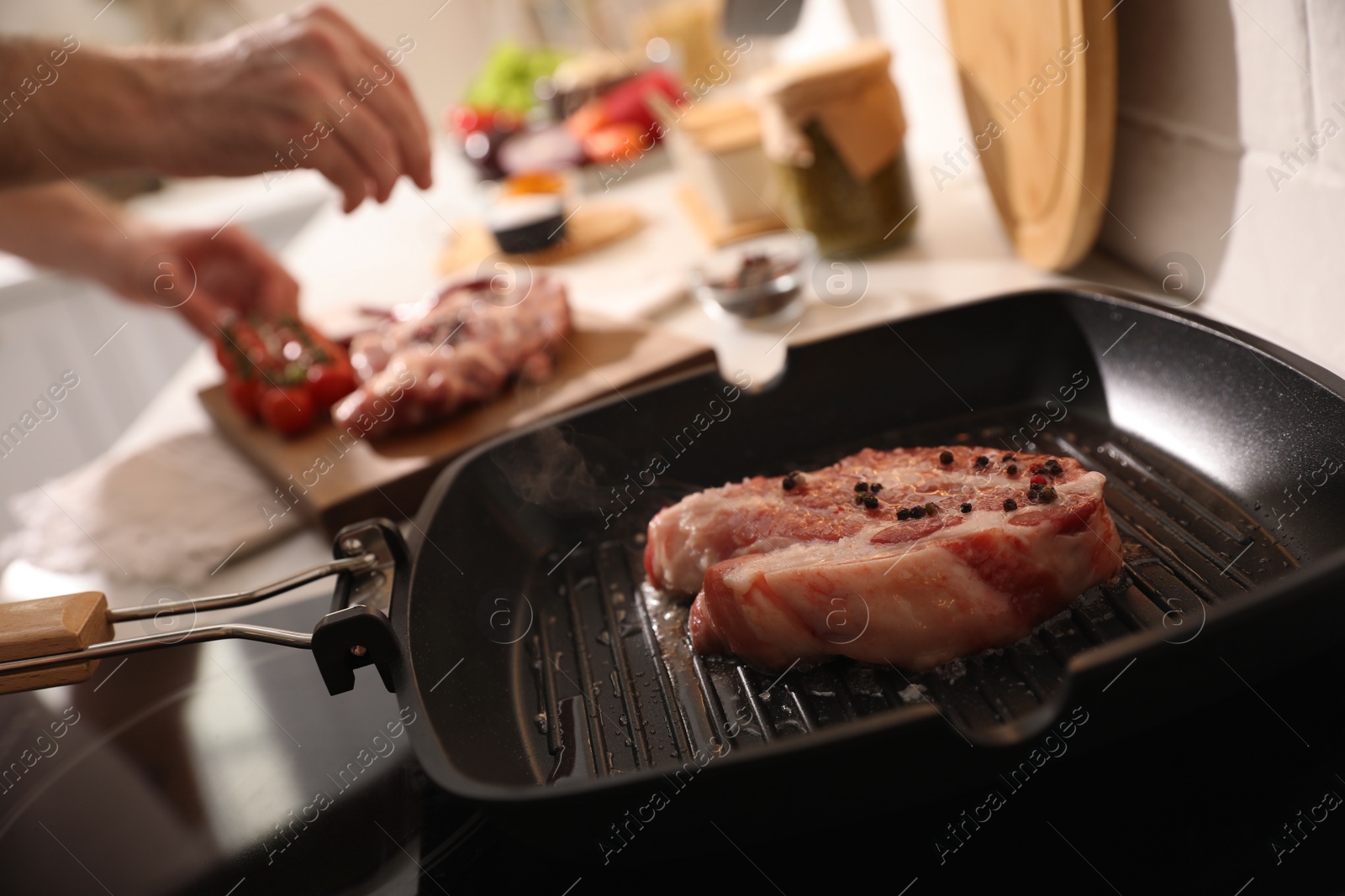 Photo of Frying pan with fresh raw meat on stove