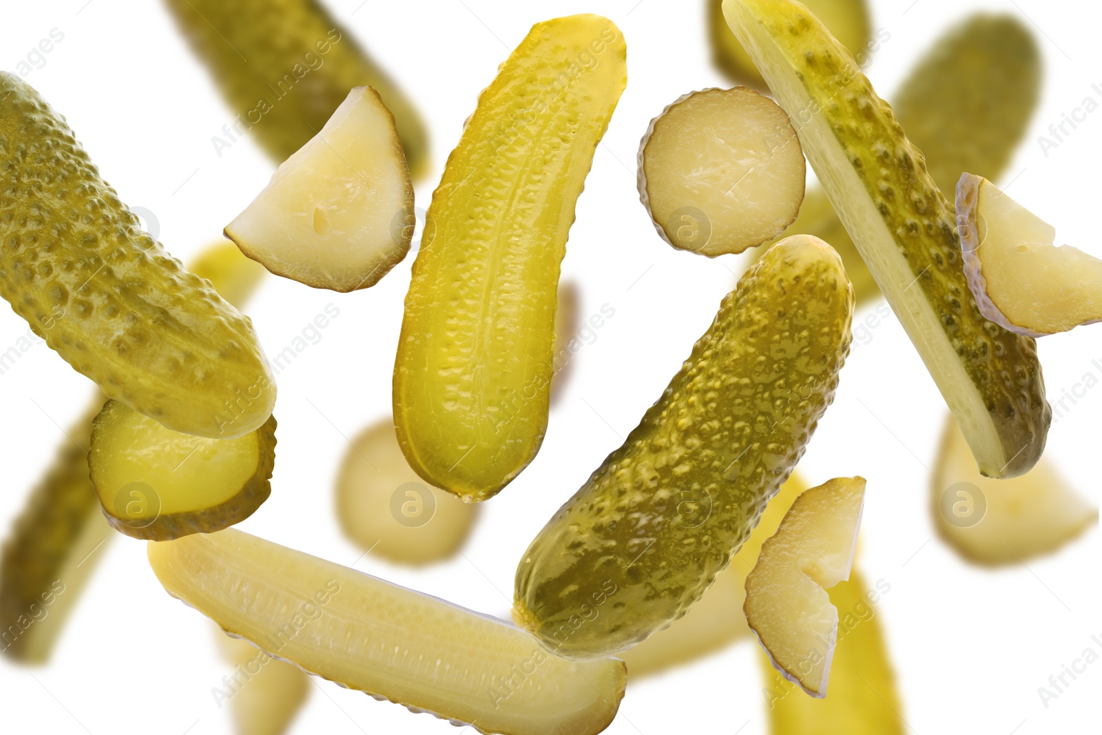 Image of Tasty pickled cucumbers falling on white background