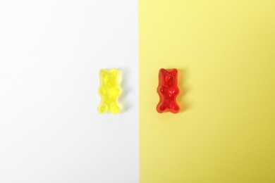 Delicious jelly bears on color background, top view