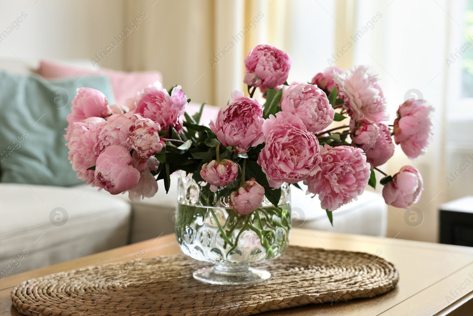 Photo of Beautiful pink peonies in vase on table at home. Interior design