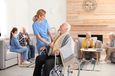 Nurses assisting elderly people at retirement home