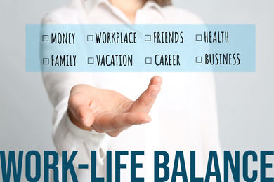 Image of Work-life balance concept. Woman demonstrating list of words on light background, closeup