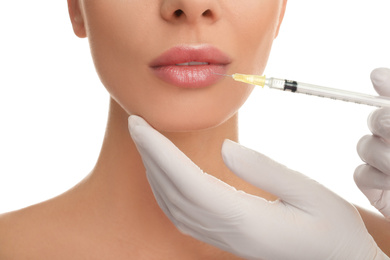 Photo of Woman getting lip injection on white background, closeup