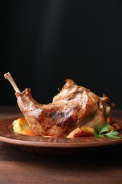 Tasty cooked rabbit meat with potatoes on wooden table