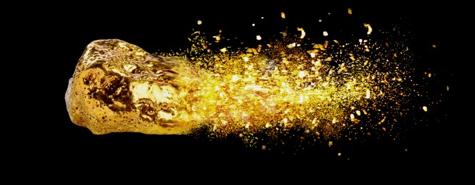 Image of Gold nugget and shiny glitter as comet on black background. Banner design