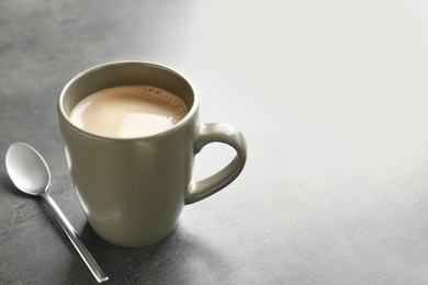 Cup of aromatic hot coffee on grey background