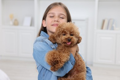 Little child with cute puppy at home. Lovely pet