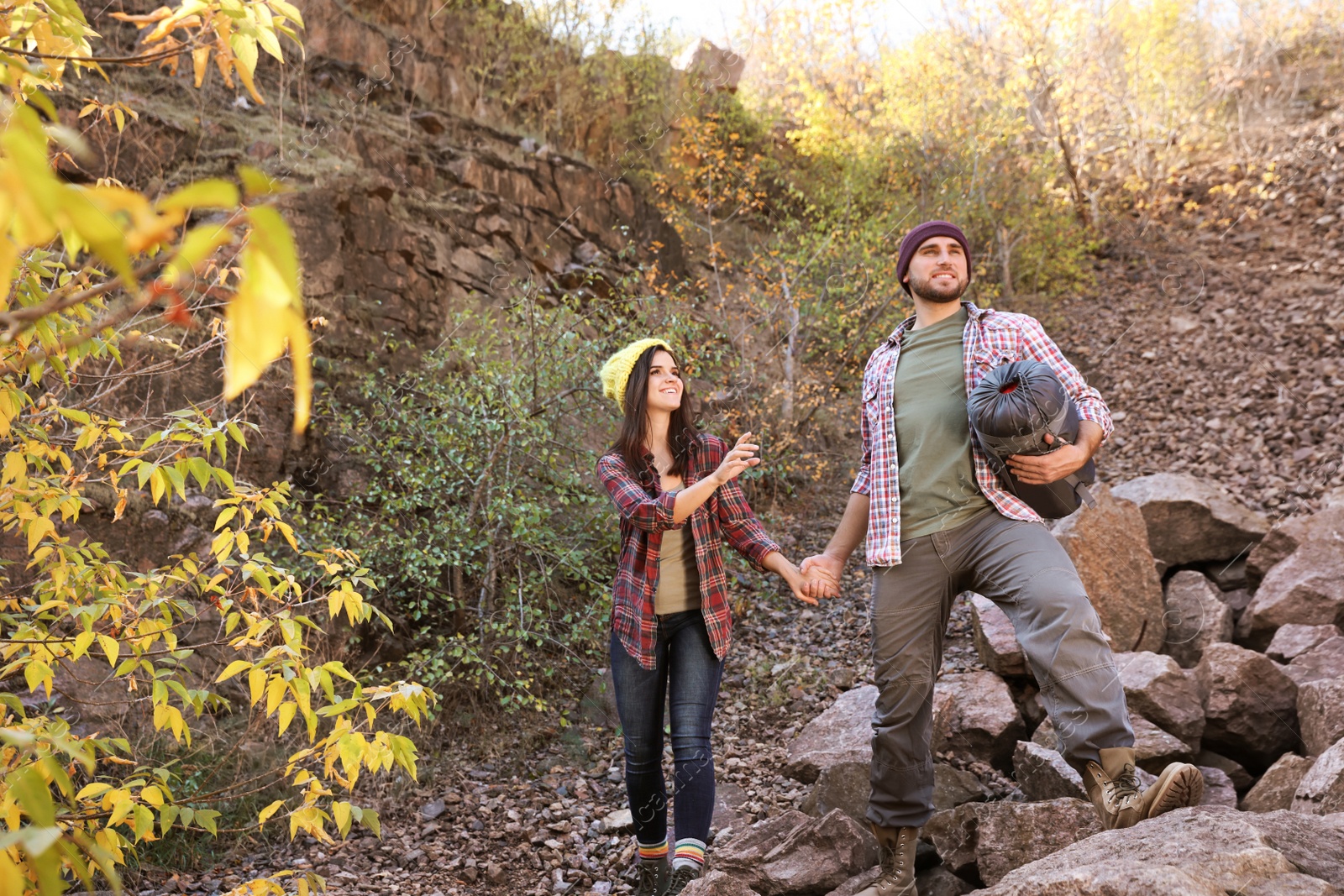 Photo of Couple of campers with sleeping bag in wilderness