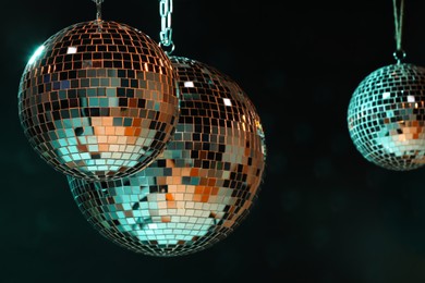 Photo of Shiny bright disco balls on dark background