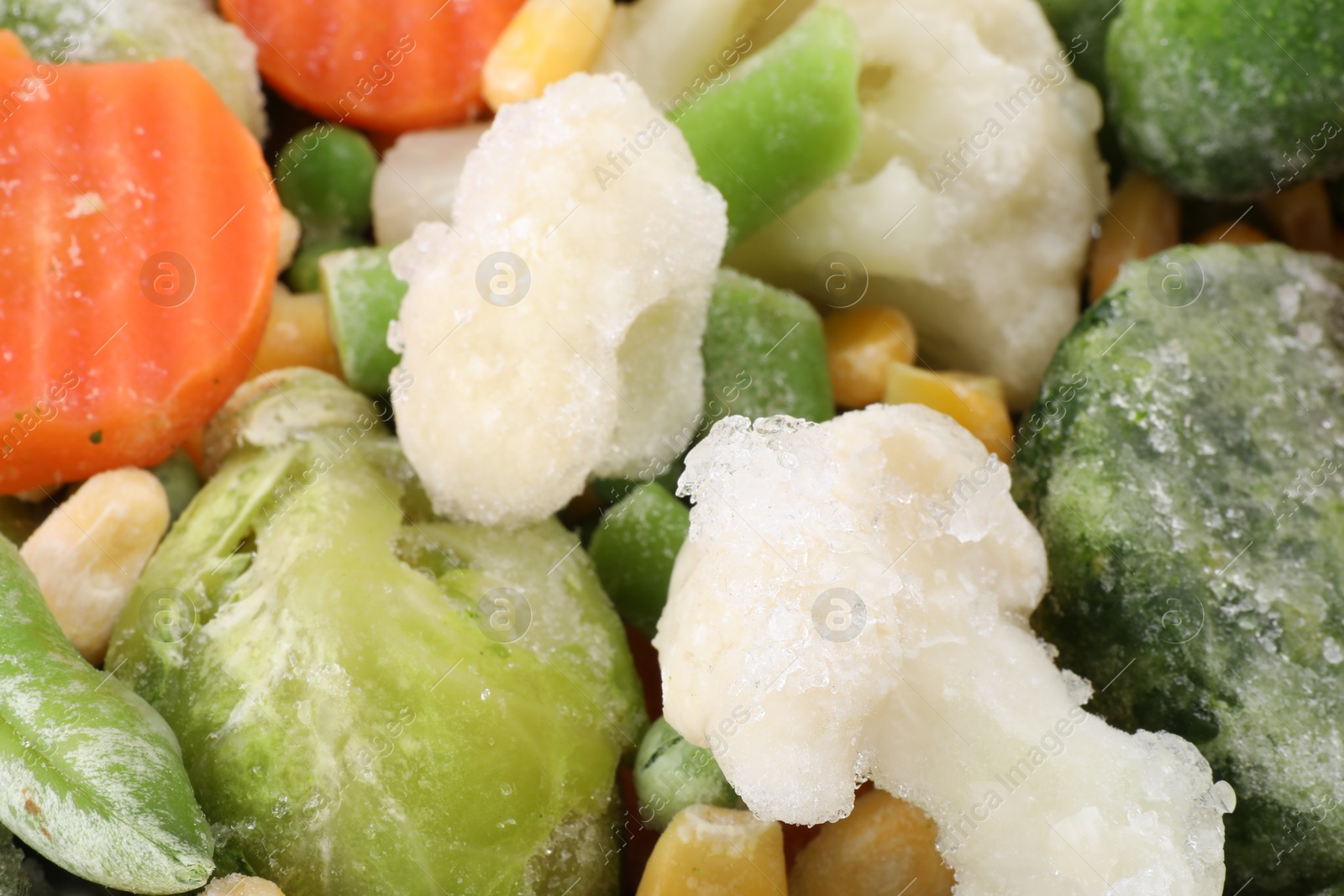 Photo of Mix of different frozen vegetables as background, closeup