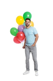 Photo of Young man holding bunch of colorful balloons on white background