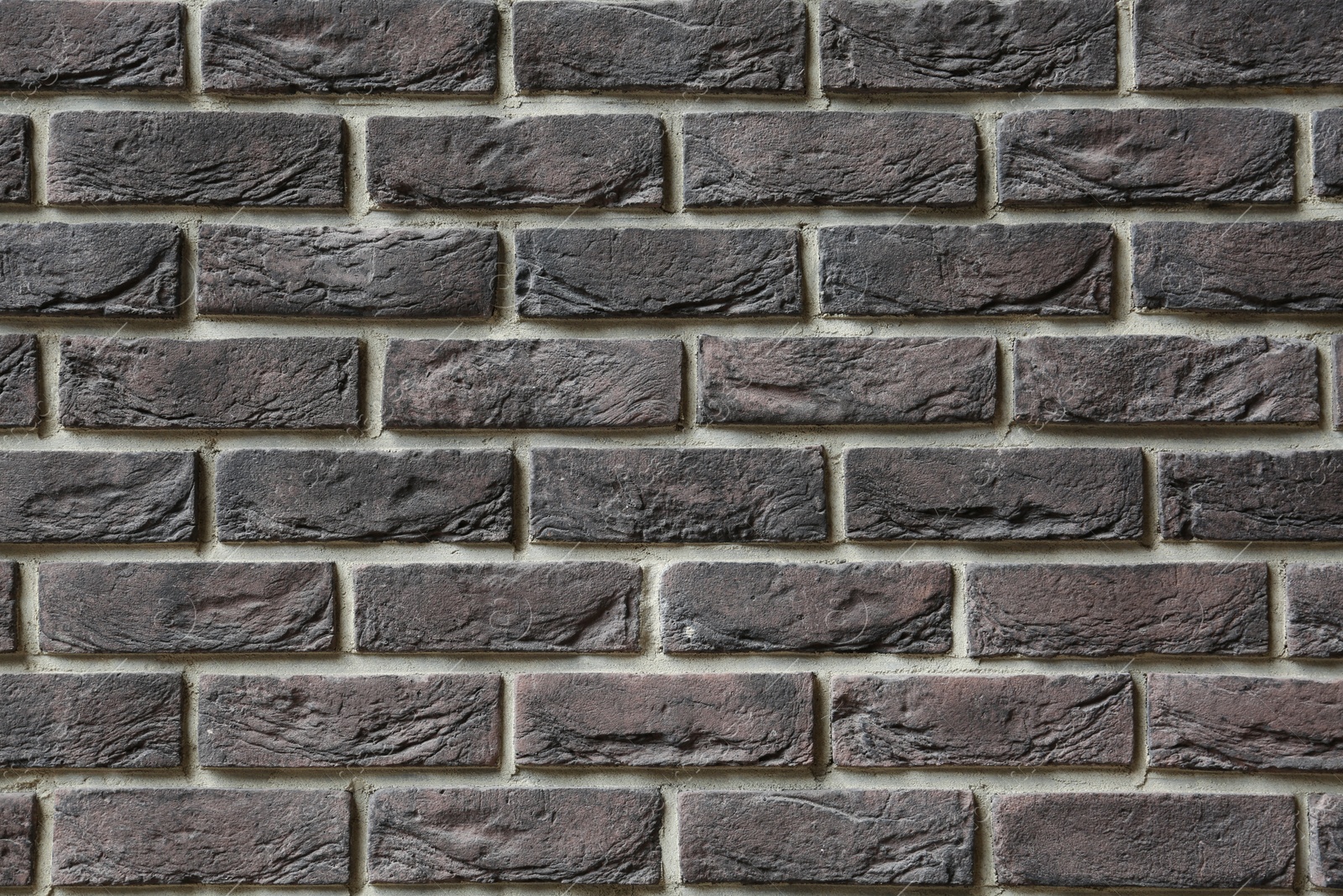 Photo of Texture of brown brick wall as background, closeup