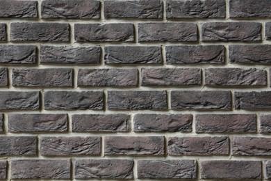 Texture of brown brick wall as background, closeup