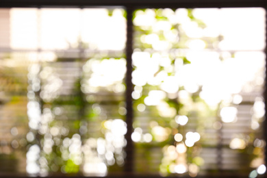 Photo of Blurred view through window on garden in morning