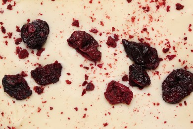 Photo of Chocolate bar with freeze dried cherries as background, closeup