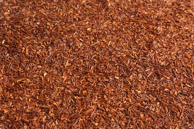 Photo of Heap of dry rooibos tea leaves as background, closeup