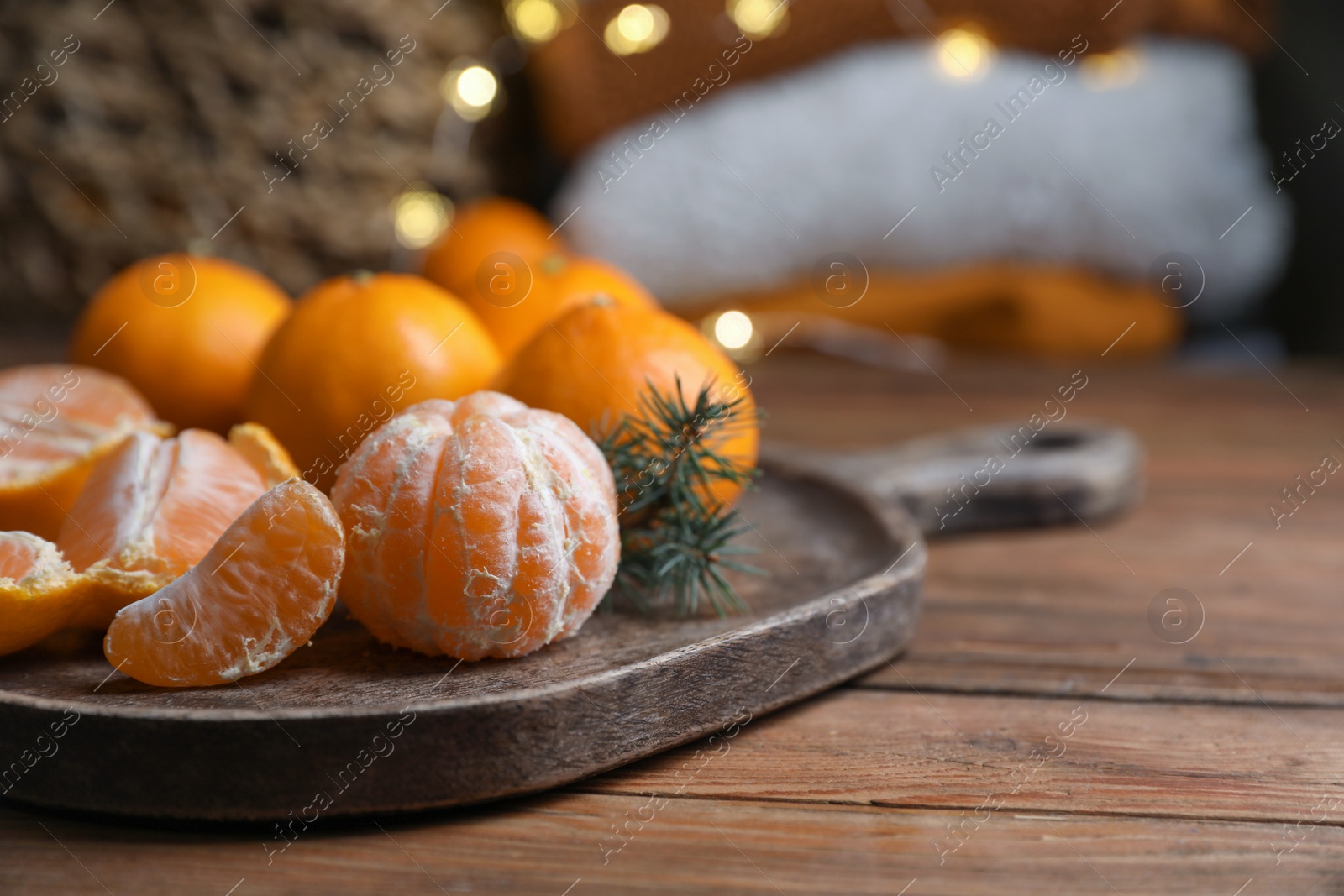 Photo of Tray with delicious ripe tangerines on wooden table. Space for text