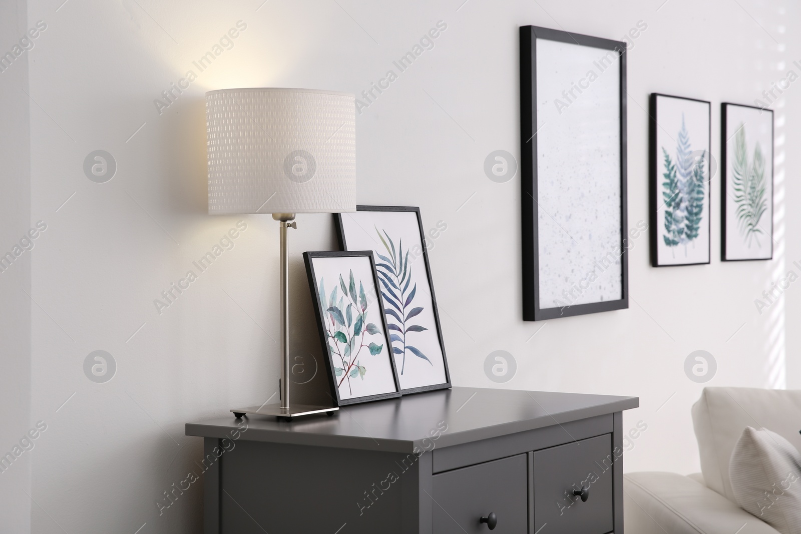 Photo of Modern room interior with grey chest of drawers