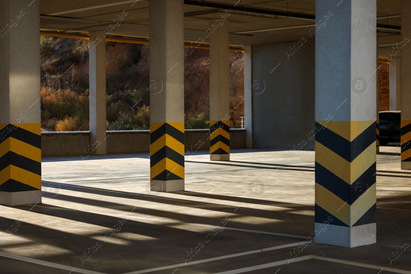 Photo of Empty open car parking garage on sunny day