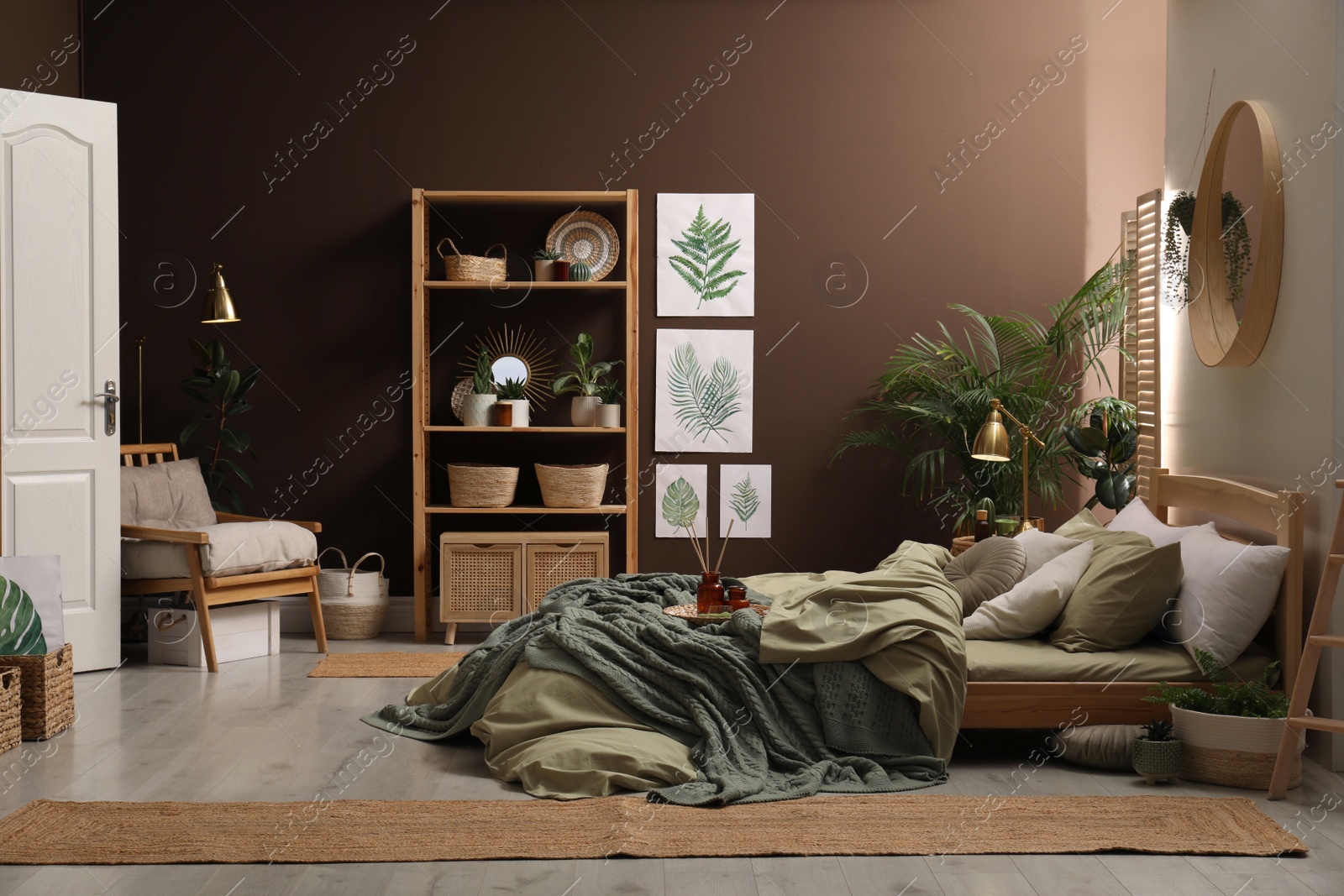 Photo of Stylish interior with large comfortable bed and potted plants