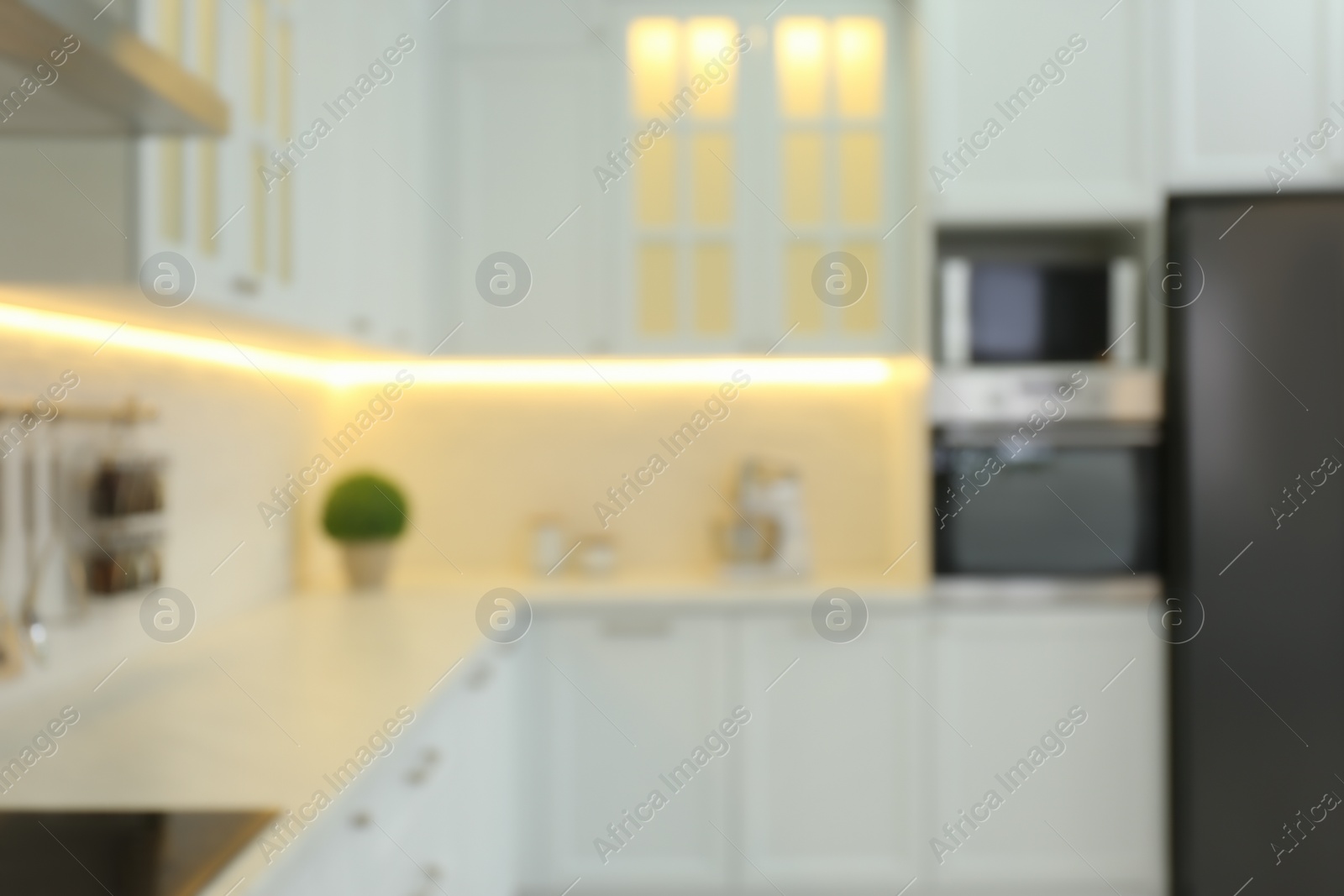 Photo of Blurred view of modern kitchen interior with stylish furniture