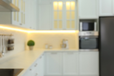 Photo of Blurred view of modern kitchen interior with stylish furniture