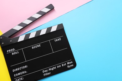 Photo of Clapperboard on color background, top view. Space for text