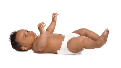 Adorable African-American baby in diaper on white background