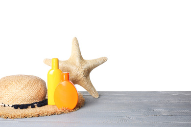 Sun protection products, hat and starfish on grey wooden table against white background. Space for text