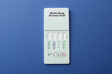 Multi-drug screen test on blue background, top view