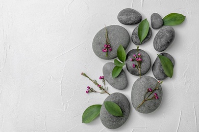 Spa stones and beautiful flowers on white background