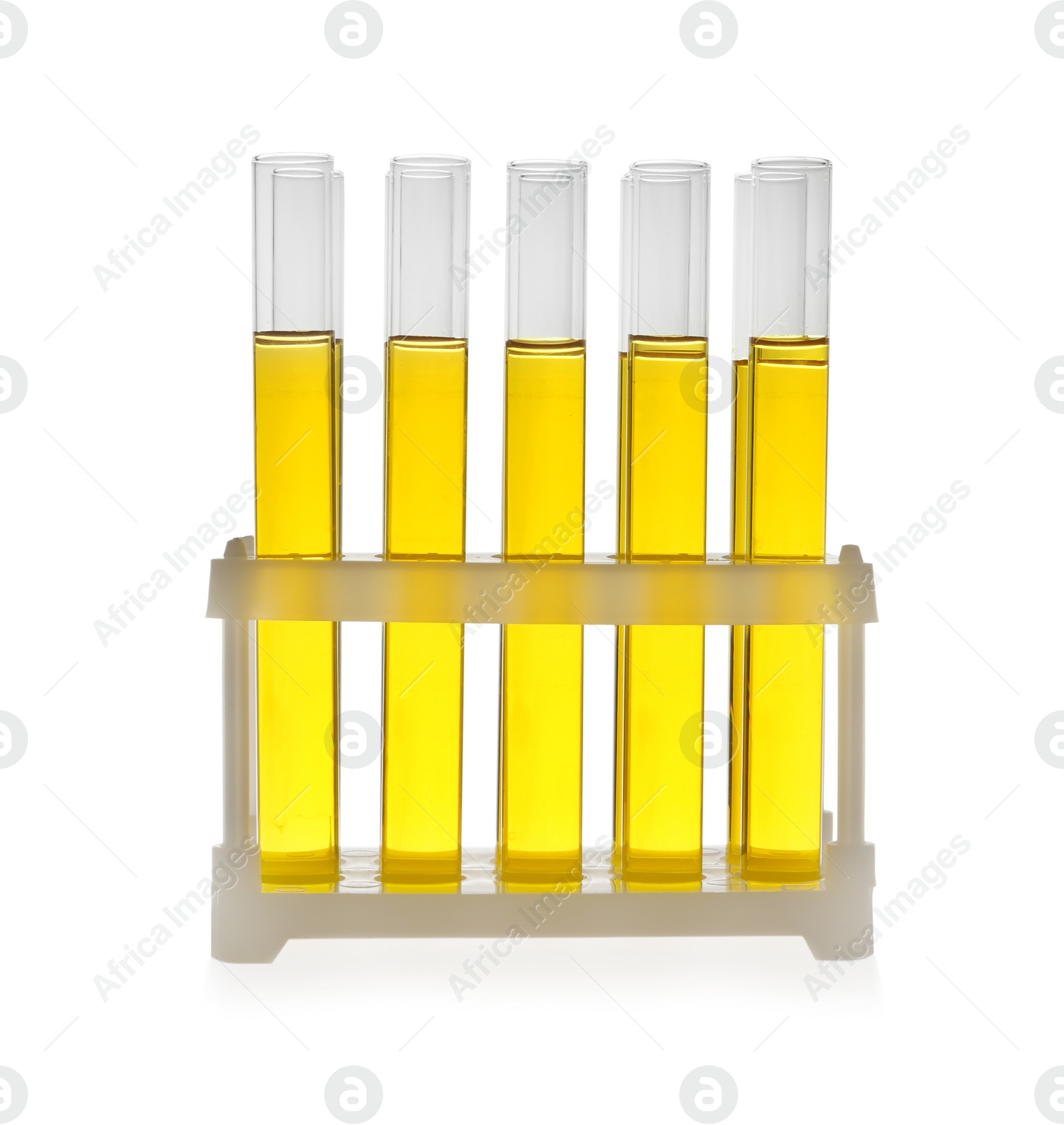 Photo of Test tubes with yellow liquid on white background