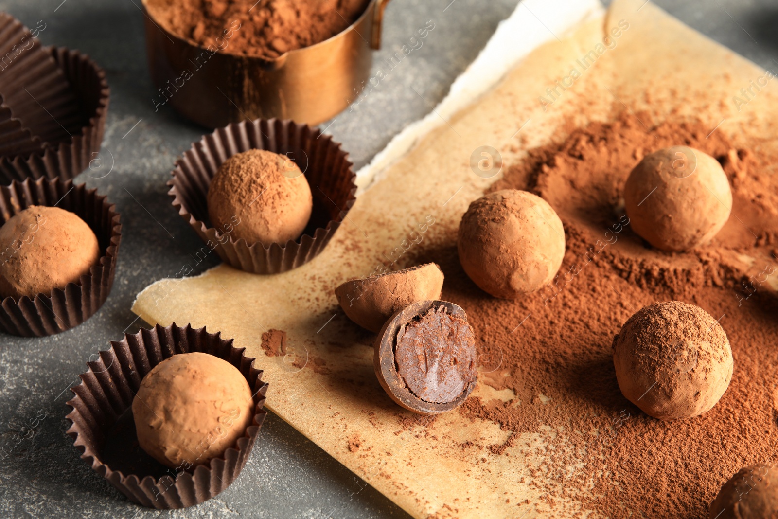 Photo of Composition with chocolate truffles on grey background
