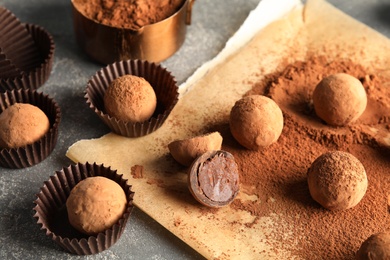 Photo of Composition with chocolate truffles on grey background