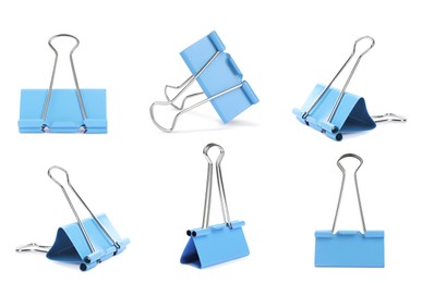 Set with light blue binder clips on white background