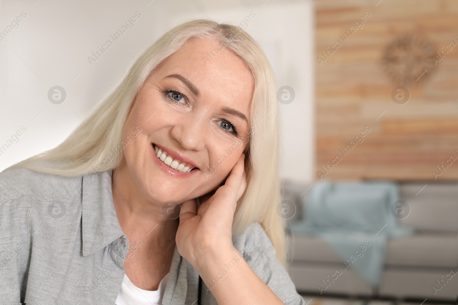 Photo of Portrait of mature woman in living room