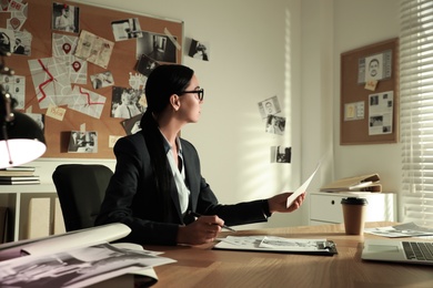 Detective working at desk in her office