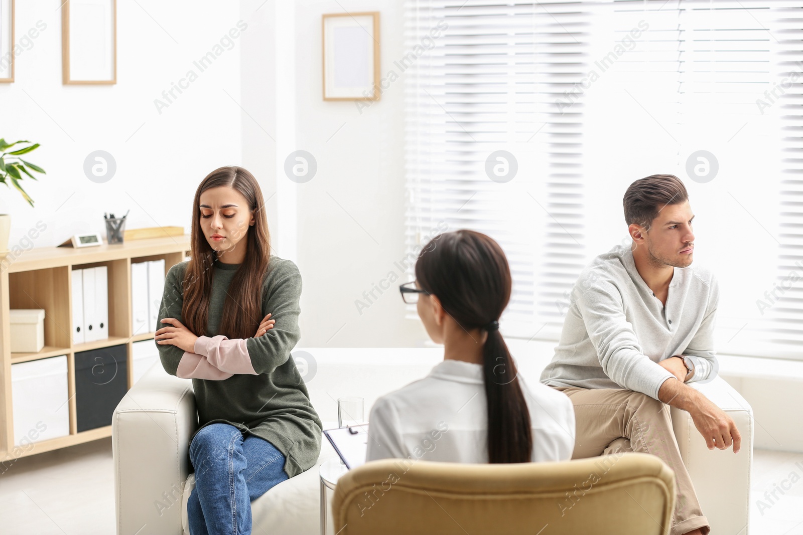 Photo of Professional psychologist working with couple in office