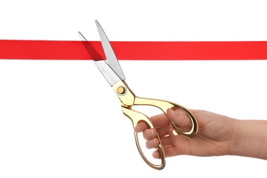 Photo of Woman cutting red ribbon with scissors on white background. Traditional ceremony