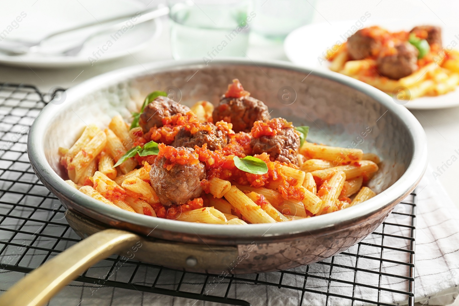 Photo of Pasta with meatballs and tomato sauce on table