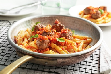 Photo of Pasta with meatballs and tomato sauce on table