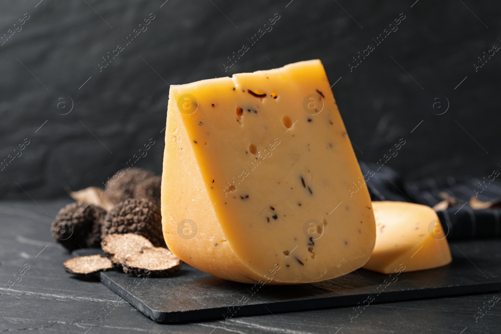 Photo of Fresh cheese and truffles on black table