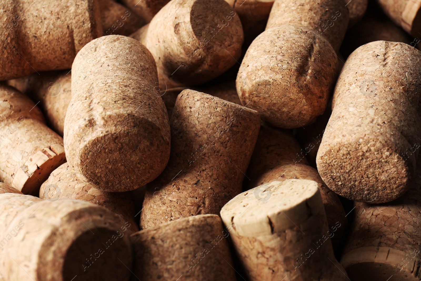 Photo of Many corks of wine bottles as background, closeup