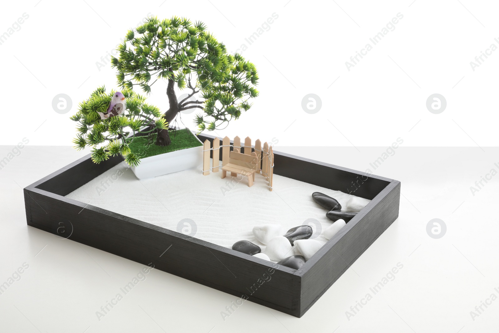 Photo of Beautiful miniature zen garden isolated on white