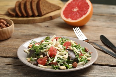 Photo of Delicious carrot salad served on wooden table