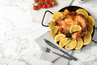 Photo of Baked chicken with orange slices on white marble table, flat lay
