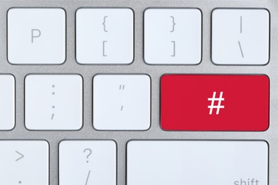 Red button with hashtag sign on computer keyboard, top view