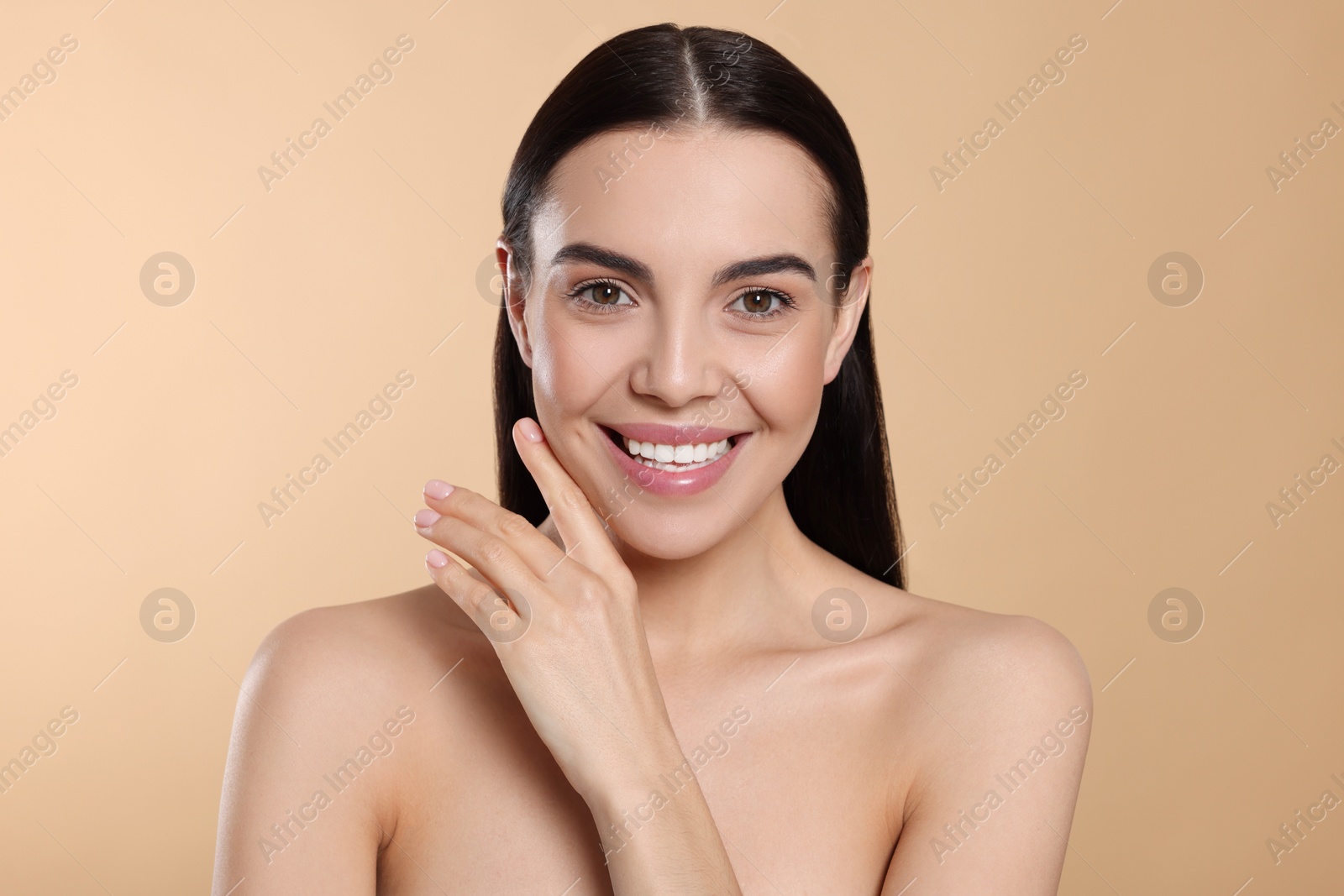 Photo of Portrait of attractive young woman on beige background. Spa treatment